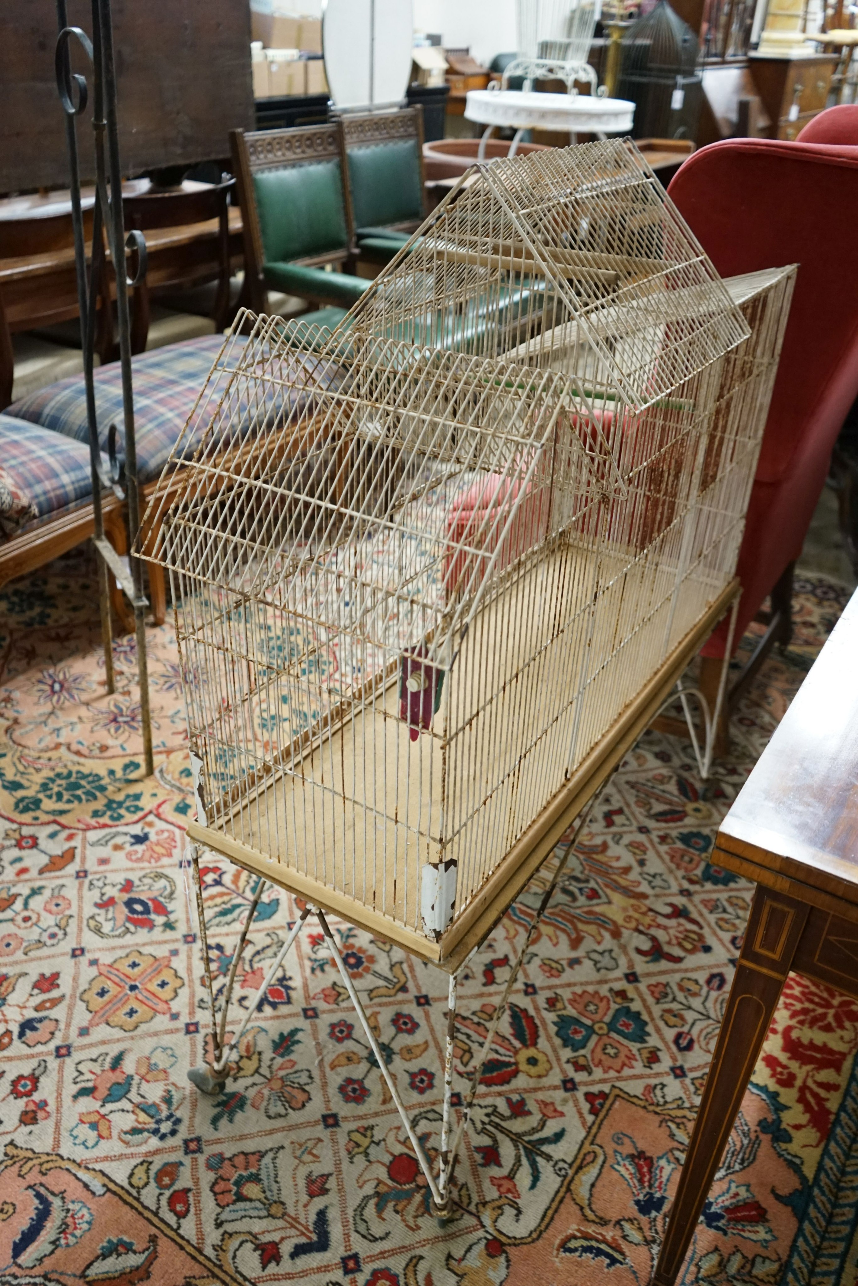 A painted wirework bird cage on stand, width 99cm, depth 36cm, height 117cm